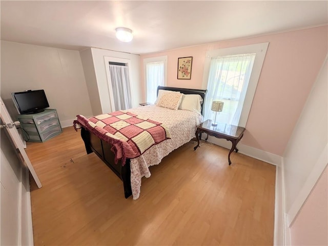 712 N Jefferson Ave, Iola, KS 66749 - bedroom featuring light wood-type flooring and baseboards