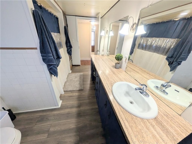 712 N Jefferson Ave, Iola, KS 66749 - bathroom featuring wood finished floors and vanity