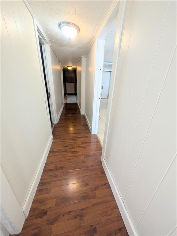 712 N Jefferson Ave, Iola, KS 66749 - hall featuring dark wood-type flooring and baseboards
