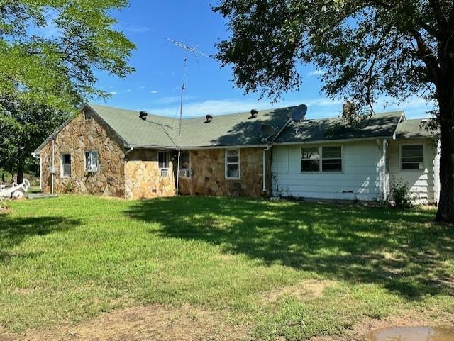 12074 S 1600th Rd, Nevada, MO 64772 - rear view of house featuring stone siding and a yard