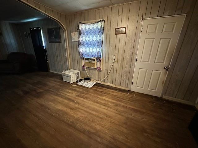 12074 S 1600th Rd, Nevada, MO 64772 - unfurnished room with arched walkways, wood finished floors, cooling unit, and wood walls
