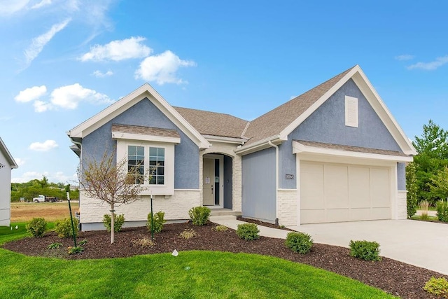 16992 S Cheshire St, Olathe, KS 66062 - view of front facade with driveway, a garage, a front yard, and stucco siding