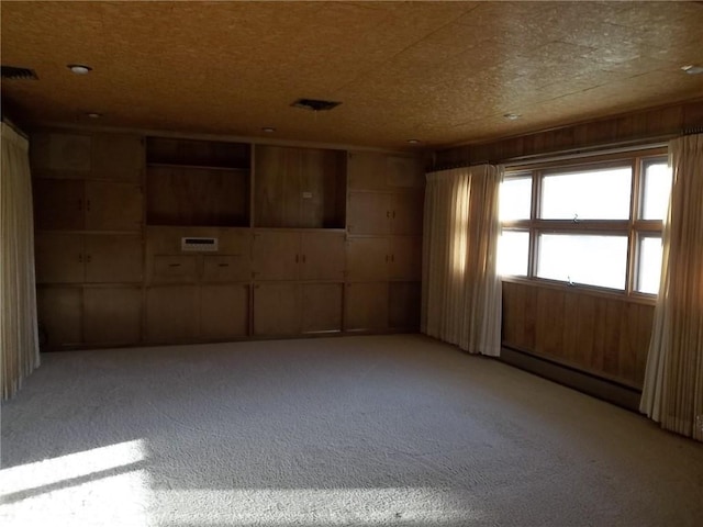 201 S Larson Ave, Chanute, KS 66720 - spare room with a baseboard radiator and light colored carpet