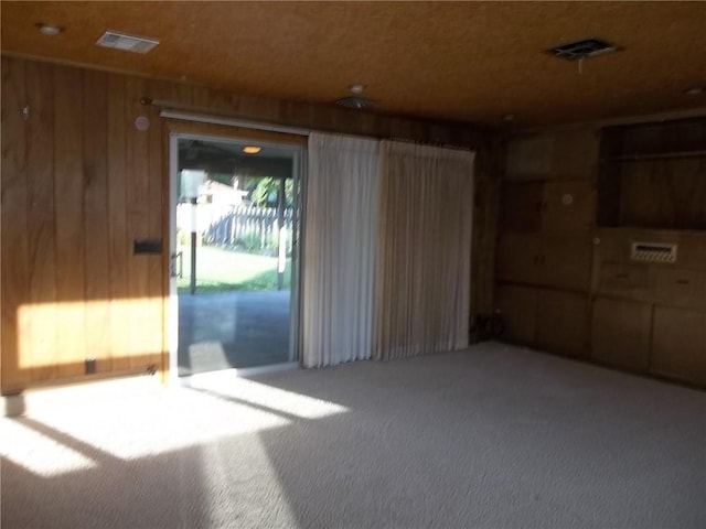 201 S Larson Ave, Chanute, KS 66720 - empty room featuring carpet flooring and wooden walls