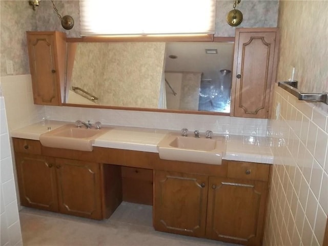 201 S Larson Ave, Chanute, KS 66720 - full bathroom with wallpapered walls, tile walls, double vanity, and wainscoting