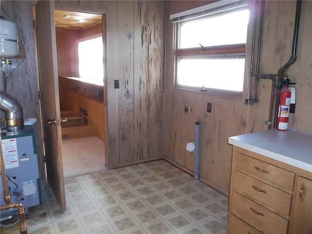 201 S Larson Ave, Chanute, KS 66720 - laundry area with light flooring, wood walls, a heating unit, and hookup for an electric dryer