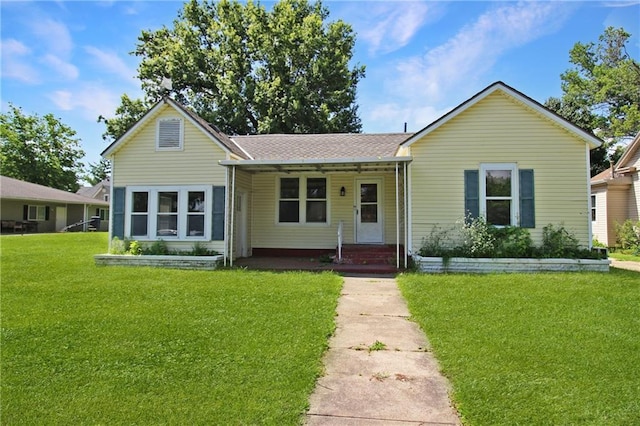 2514 Belmont Ave, Parsons, KS 67357 - view of front of home with a front lawn, covered porch, and roof with shingles