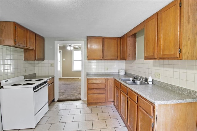 2514 Belmont Ave, Parsons, KS 67357 - kitchen featuring electric range, ceiling fan, a textured ceiling, backsplash, and light tile patterned floors