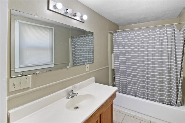 2514 Belmont Ave, Parsons, KS 67357 - full bathroom with vanity, shower / bath combo with shower curtain, tile patterned flooring, and a textured ceiling