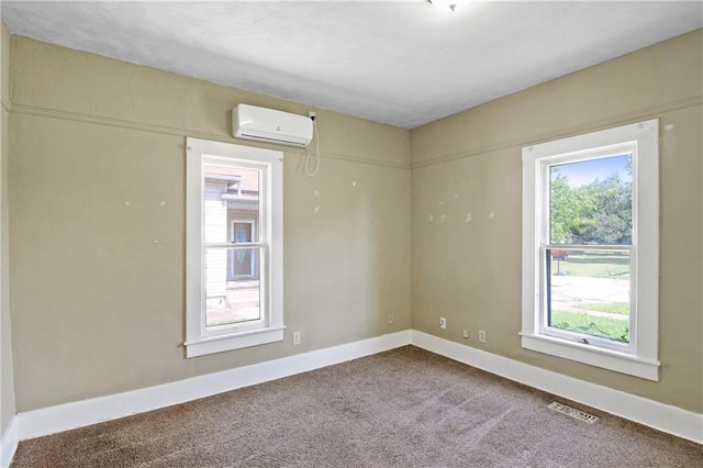 2514 Belmont Ave, Parsons, KS 67357 - carpeted empty room featuring a wall mounted AC and baseboards