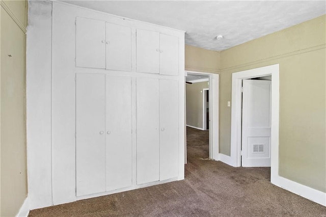 2514 Belmont Ave, Parsons, KS 67357 - unfurnished bedroom featuring dark carpet and baseboards