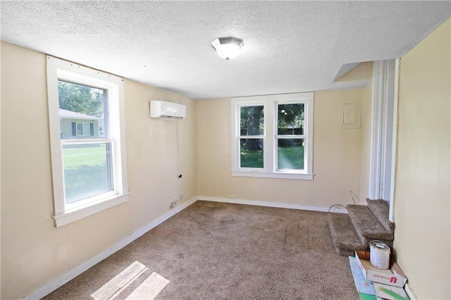 2514 Belmont Ave, Parsons, KS 67357 - empty room with a wall mounted air conditioner, a textured ceiling, and carpet floors