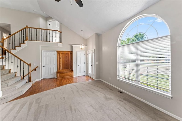 1103 N 2nd St E, Louisburg, KS 66053 - carpeted entryway featuring a ceiling fan, stairs, and high vaulted ceiling