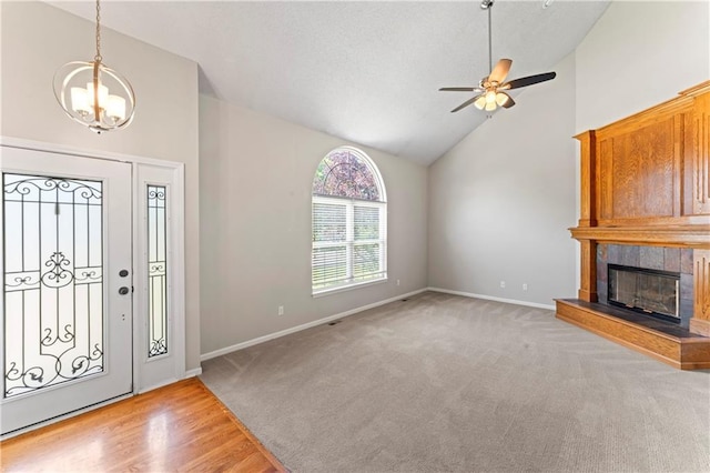 1103 N 2nd St E, Louisburg, KS 66053 - foyer with a chandelier, a ceiling fan, light carpet, a fireplace, and high vaulted ceiling
