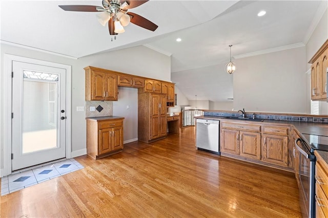 1103 N 2nd St E, Louisburg, KS 66053 - kitchen featuring appliances with stainless steel finishes, brown cabinetry, a ceiling fan, vaulted ceiling, and dark countertops
