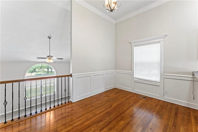 1103 N 2nd St E, Louisburg, KS 66053 - spare room featuring a ceiling fan, wood finished floors, a wainscoted wall, a chandelier, and crown molding