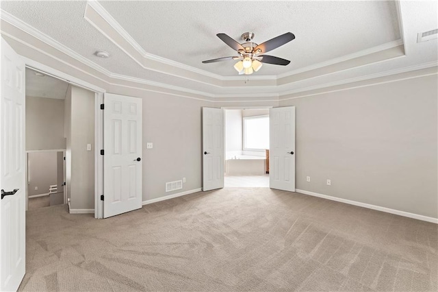 1103 N 2nd St E, Louisburg, KS 66053 - carpeted spare room with a raised ceiling, ornamental molding, ceiling fan, and a textured ceiling