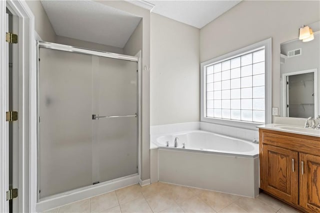1103 N 2nd St E, Louisburg, KS 66053 - full bathroom with vanity, a garden tub, a shower stall, and tile patterned flooring