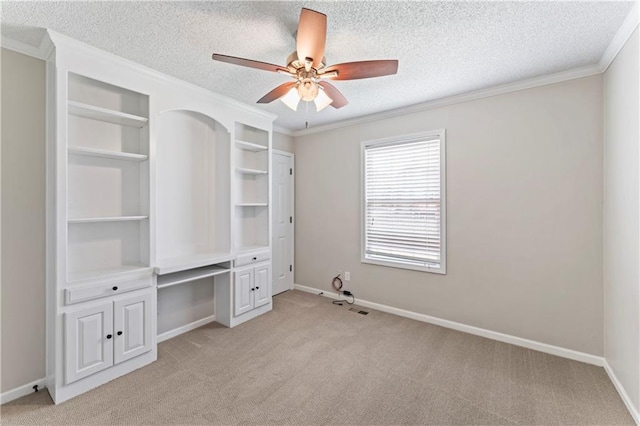 1103 N 2nd St E, Louisburg, KS 66053 - unfurnished bedroom featuring a textured ceiling, light carpet, crown molding, and a ceiling fan