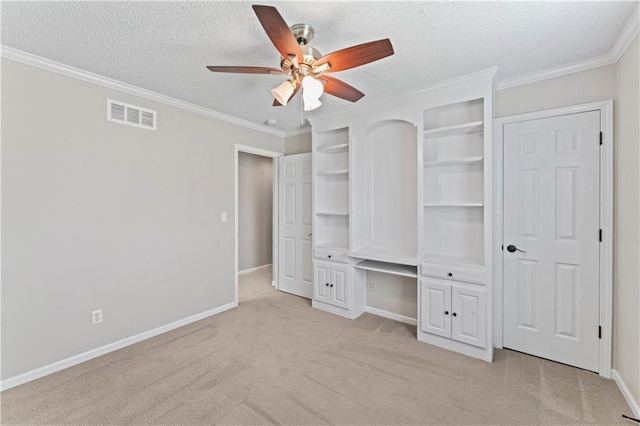 1103 N 2nd St E, Louisburg, KS 66053 - unfurnished bedroom with light colored carpet, crown molding, a textured ceiling, and a ceiling fan