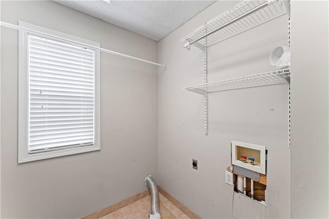 1103 N 2nd St E, Louisburg, KS 66053 - laundry room with electric dryer hookup, tile patterned flooring, and washer hookup