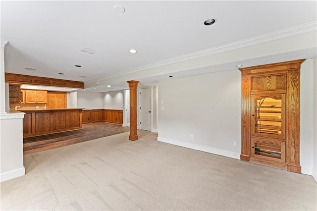 1103 N 2nd St E, Louisburg, KS 66053 - unfurnished living room with light colored carpet, ornate columns, ornamental molding, recessed lighting, and bar with sink