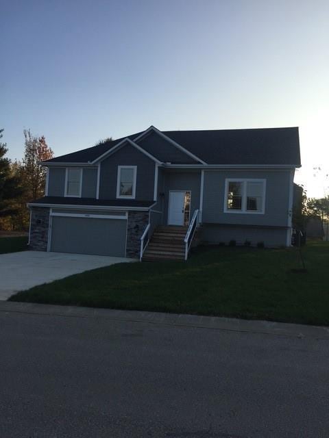3812 SW Mcdanial Ave, Blue Springs, MO 64015 - view of front of home featuring an attached garage, concrete driveway, and a front lawn