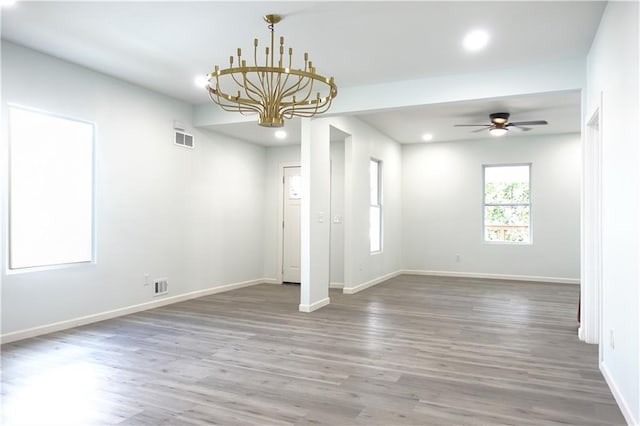5032 E 8th St, Kansas City, MO 64124 - spare room with wood finished floors, recessed lighting, a chandelier, and a ceiling fan