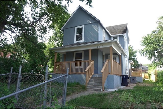 5032 E 8th St, Kansas City, MO 64124 - view of front of property featuring covered porch, a gate, and roof with shingles