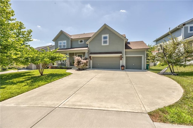 23317 W 52nd Ter, Shawnee, KS 66226 - view of front of house with a front lawn, driveway, a garage, and covered porch