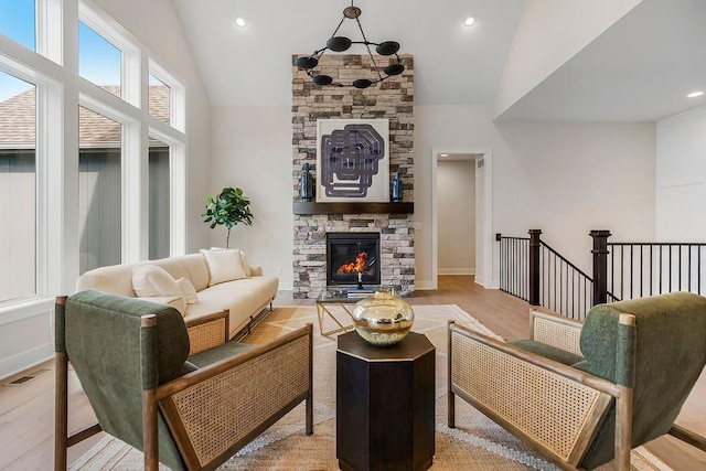 16567 W 170th St, Olathe, KS 66062 - living area featuring light wood finished floors, high vaulted ceiling, and a fireplace