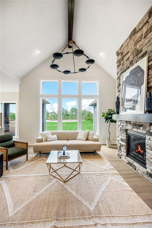 16567 W 170th St, Olathe, KS 66062 - living area with wood finished floors, plenty of natural light, a fireplace, and recessed lighting