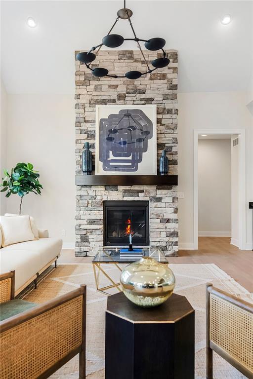 16567 W 170th St, Olathe, KS 66062 - living area with a stone fireplace and recessed lighting