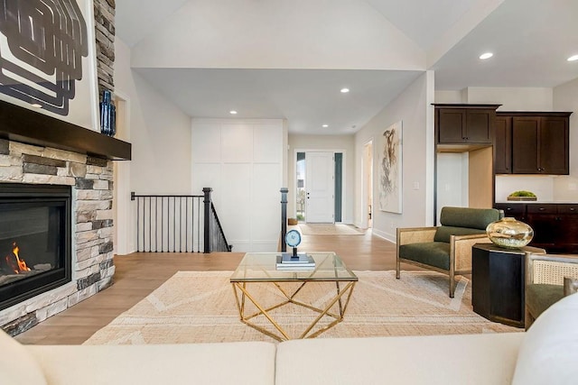 16567 W 170th St, Olathe, KS 66062 - living area featuring vaulted ceiling, light wood-style floors, a stone fireplace, and recessed lighting