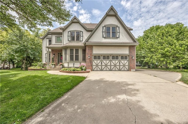 11508 Hauser St, Overland Park, KS 66210 - view of front of home with concrete driveway, a front lawn, stucco siding, an attached garage, and brick siding