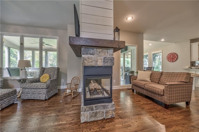 11508 Hauser St, Overland Park, KS 66210 - living room with wood finished floors, a stone fireplace, and recessed lighting