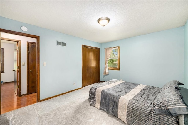 7608 N Serene Ave, Kansas City, MO 64152 - bedroom featuring a closet, a textured ceiling, and carpet