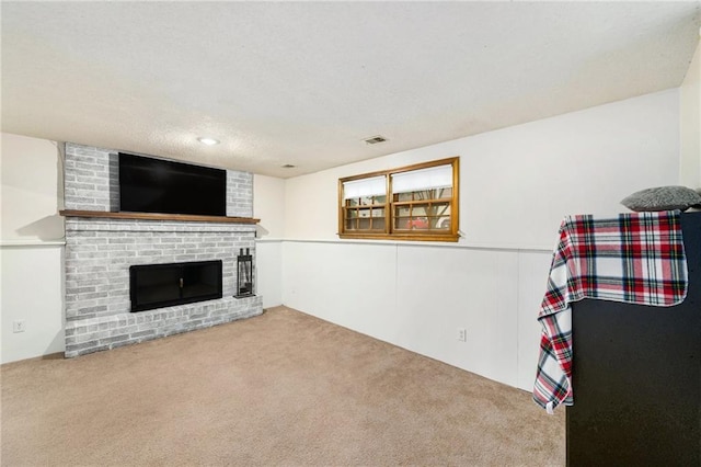 7608 N Serene Ave, Kansas City, MO 64152 - carpeted living area featuring a fireplace, a wainscoted wall, and a textured ceiling