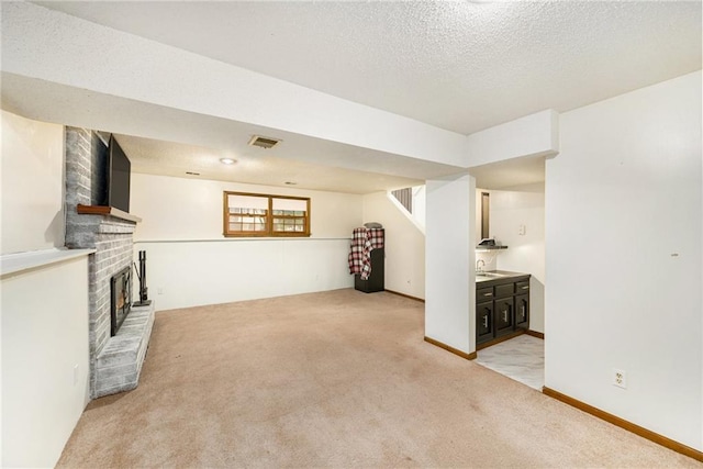 7608 N Serene Ave, Kansas City, MO 64152 - unfurnished living room with light colored carpet, a fireplace, stairway, and a textured ceiling