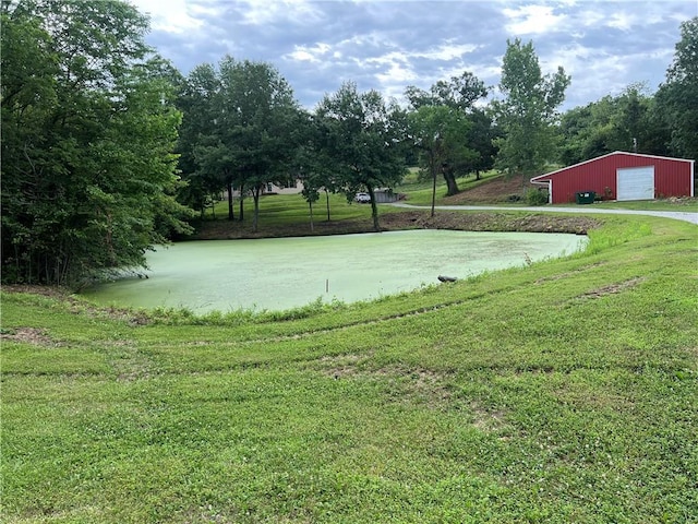 36987 W 63rd St, Camden, MO 64017 - view of grassy yard featuring a detached garage, an outdoor structure, driveway, and an outbuilding