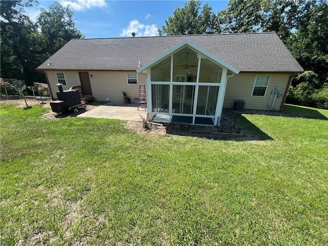 36987 W 63rd St, Camden, MO 64017 - back of house featuring a sunroom, a patio area, a lawn, and roof with shingles