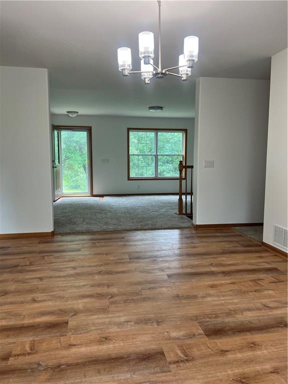 36987 W 63rd St, Camden, MO 64017 - empty room with a chandelier and wood finished floors