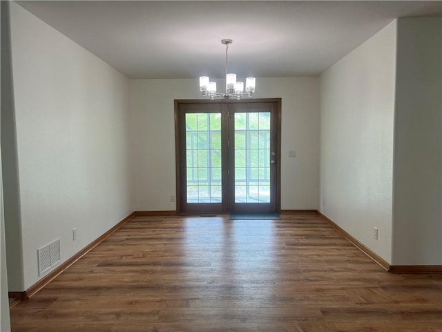 36987 W 63rd St, Camden, MO 64017 - unfurnished dining area featuring a chandelier and wood finished floors