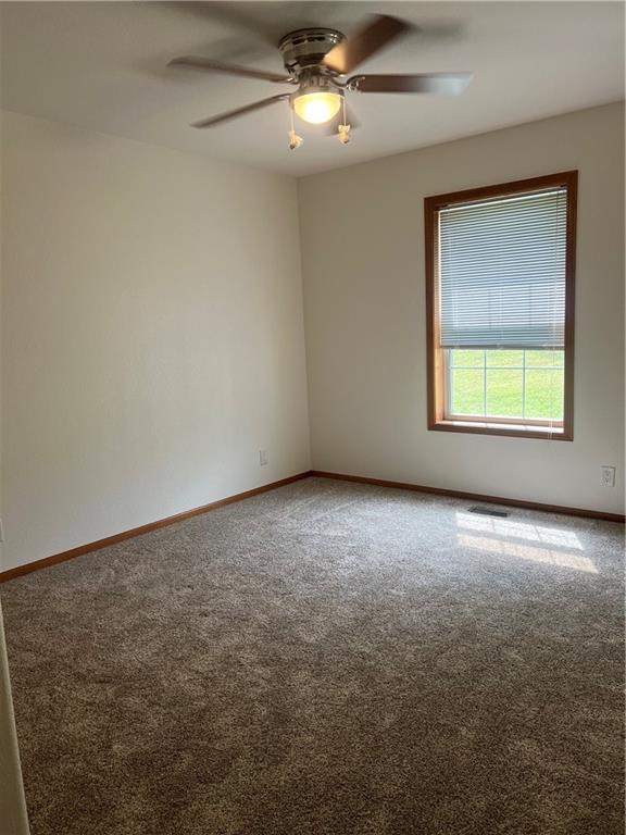 36987 W 63rd St, Camden, MO 64017 - carpeted spare room with a ceiling fan and baseboards