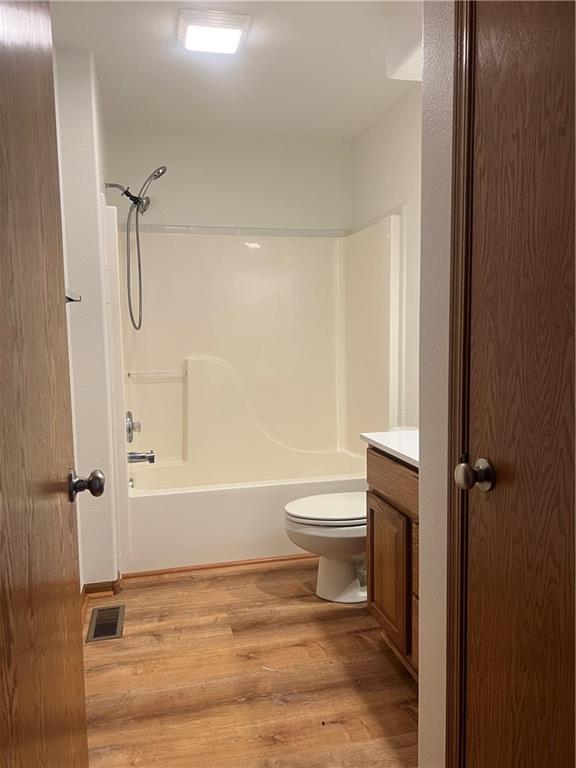 36987 W 63rd St, Camden, MO 64017 - full bath with vanity, wood finished floors, and tub / shower combination