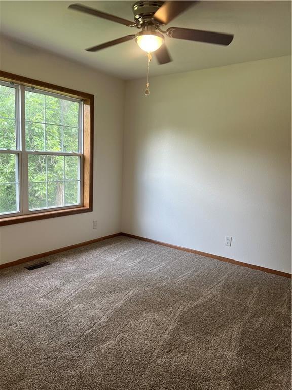 36987 W 63rd St, Camden, MO 64017 - carpeted spare room with a ceiling fan and baseboards