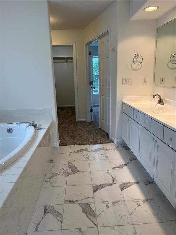 36987 W 63rd St, Camden, MO 64017 - full bath featuring vanity, a garden tub, and a walk in closet