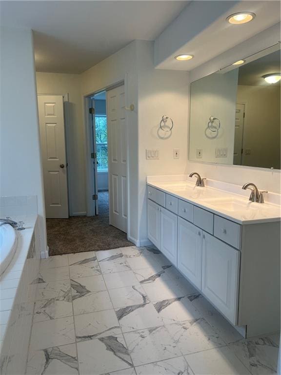 36987 W 63rd St, Camden, MO 64017 - bathroom featuring double vanity, a garden tub, and recessed lighting