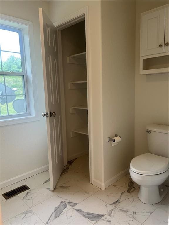 36987 W 63rd St, Camden, MO 64017 - bathroom featuring marble look tiles and plenty of natural light