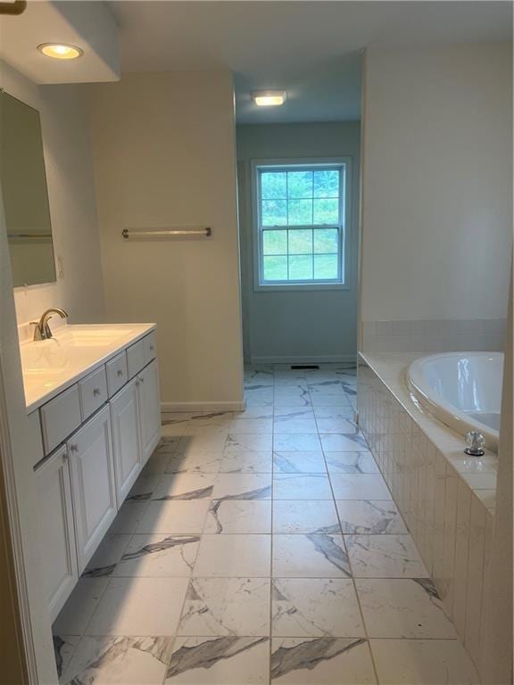 36987 W 63rd St, Camden, MO 64017 - bathroom featuring vanity, a garden tub, marble finish floors, and recessed lighting